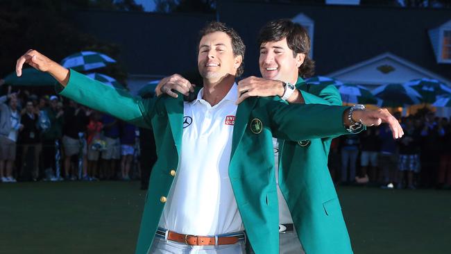 Adam Scott receives his green jacket from 2012 Masters champion Bubba Watson. Picture: Getty