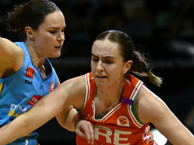 TOWNSVILLE, AUSTRALIA - NOVEMBER 16: Courtney Woods of the Townsville Fire gets past Kelly Wilson of the Spirit during the round three WNBL match between Townsville Fire and Bendigo Spirit at Townsville Entertainment Centre, on November 16, 2024, in Townsville, Australia. (Photo by Albert Perez/Getty Images)