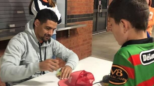 Cody Walker signing autographs for Rabbitohs fans on visit to the bush this week. 