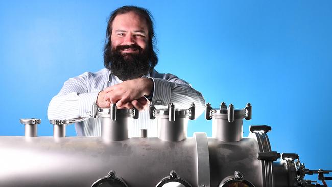 Neumann Space founder Patrick Neumann with his invention, a prototype vacuum chamber for a space plasma thruster. Picture: AAP/Mark Brake