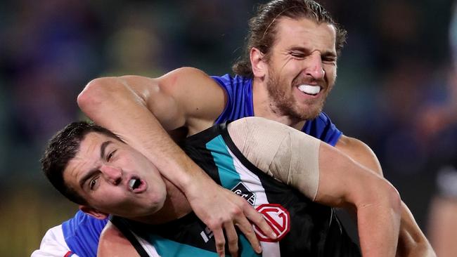 Western Bulldogs star Marcus Bontempelli grapples with Port Adelaide’s Tom Rockliff on Monday night. Picture: AFL Photos