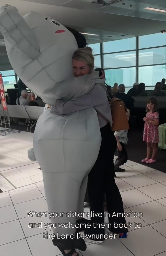 A "mortified" Chelsea Bartlett hugs her sister Janelle, in the koala costume, at the Brisbane airport in this screenshot from a now viral video first shared to her Instagram account. Janelle dressed as a koala to surprise her sisters. Picture: @janellejoy_