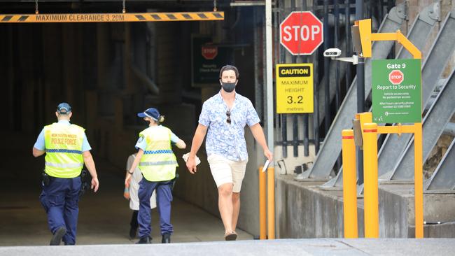 A man is escorted out by police and was given a fine at the SCG on Thursday. Picture: Christian Gilles