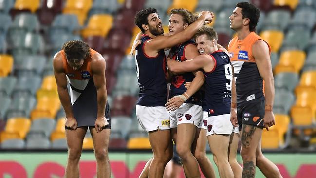 Melbourne players celebrate after the final siren having knocked off GWS in a thriller. Picture: Albert Perez/Getty Images