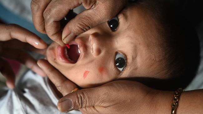 A health worker administers vaccine to a child in Mumbai. Picture: AFP