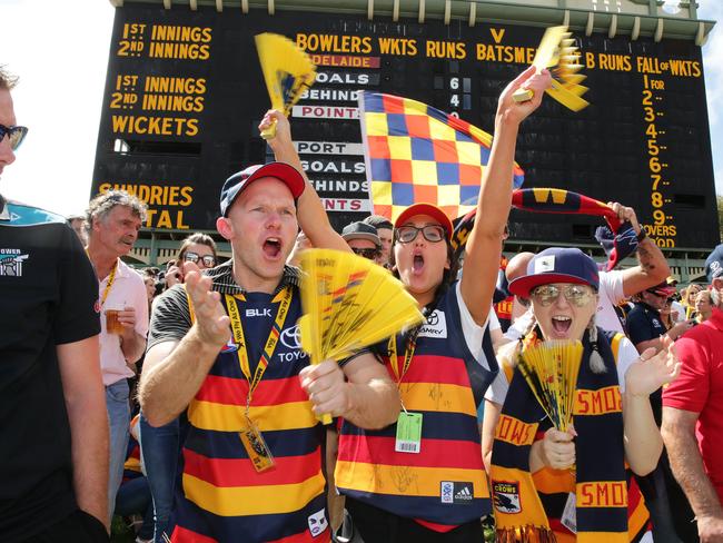 Crows fans Billy Sheppard, Krystal Kennedy, and Calliope Delinicolas cheer a goal. Picture: Dylan Coker