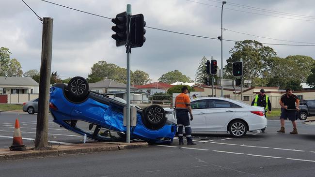 Car flips onto roof after crash at busy intersection