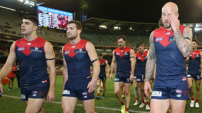 AFL Round 22. 16/08/2019. Melbourne v Sydney at the MCG .  A disappointed Melbourne outfit trudge off the MCG after tonights loss   . Pic: Michael Klein