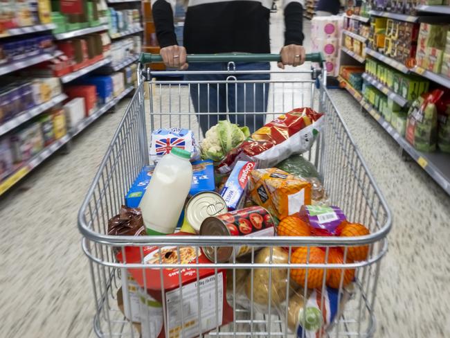 CARDIFF, WALES - MAY 22: A woman with a shopping trolley full of groceries in a supermarket aisle on May 22, 2022 in Cardiff, Wales. Last week, the UK Office for National Statistics reported an 6% average increase of food and drink prices year on year, but some staples, such as milk and pasta, had risen by more than 10%. (Photo by Matthew Horwood/Getty Images)