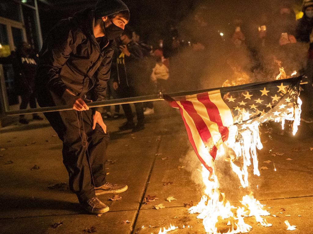 A protester burns an American Flag following a vigil for Kevin Peterson Jr. Picture: Nathan Howard/Getty Images/AFP