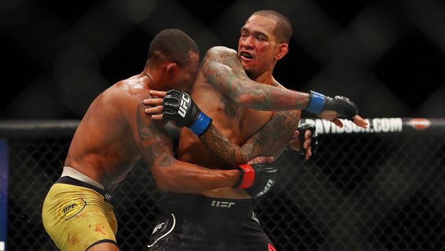 Yancy Medeiros (R) battles Alex Oliveira (L) during UFC 218 .