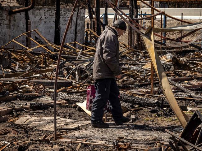 A man walks near the rubble of a destroyed house in the village of Zalissya, northeast of Kyiv. Picture: AFP