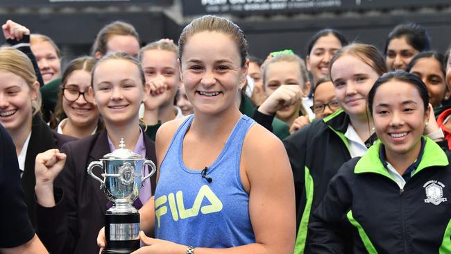 French Open winner and world number one tennis player Ashleigh Barty (centre) is seen holding the French Open trophy after being welcomed home at Pat Rafter Arena in Brisbane, (AAP Image/Darren England)