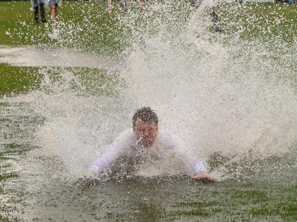 Rain, hail or shine punters were out in Flemington for a good time. Picture: Jason Edwards