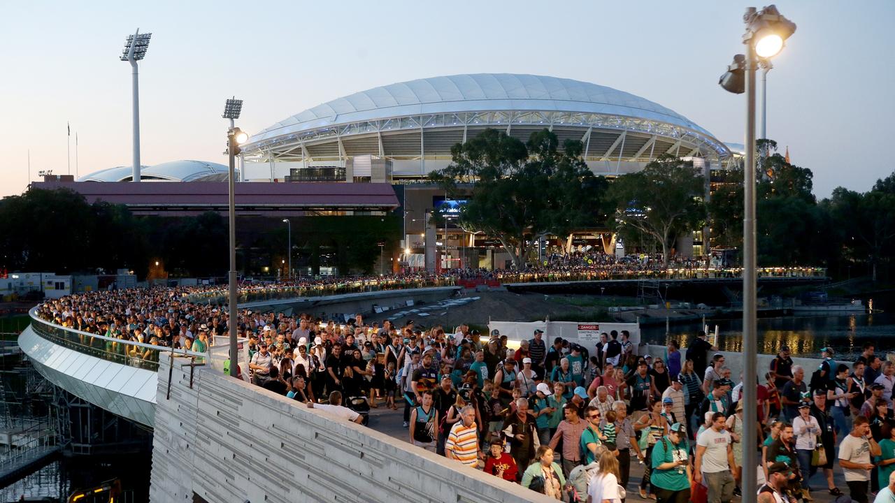 Fans leave across the Torrens footbridge after the first AFL match at the newly renovated Adelaide Oval between Adelaide and Port Adelaide. 