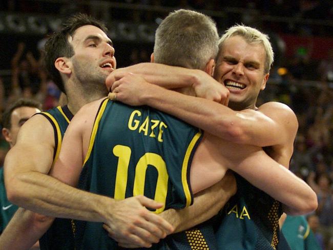 Andrew Gaze is hugged by teammates Sam Mackinnon (L) and Shane Heal during the Sydney Games. Picture: David Kapernick