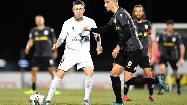 Liam Shipton of the Magpies Crusaders passes the ball under pressure during the match between Magpies Crusaders United and Macarthur FC at BB Print Stadium on July 30, 2022 in Mackay, Australia. Picture: Albert Perez/Getty Images