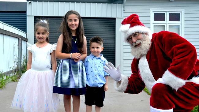 Santa Claus visits Leila, 7, Jasmine, 5, and Ali Mohamad during their home quarantine. Picture: HEIDI ROBNIK.