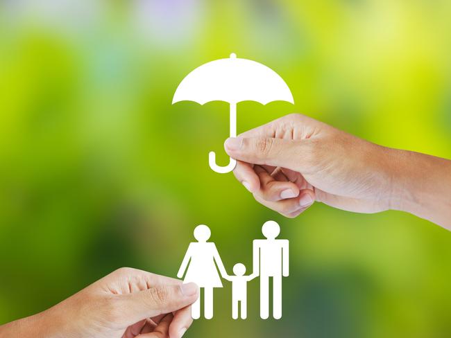 Hand holding a paper family and umbrella on green background concept income protection insurance generic, life insurance, family