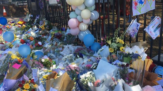 Floral tributes at the front gate of the school.