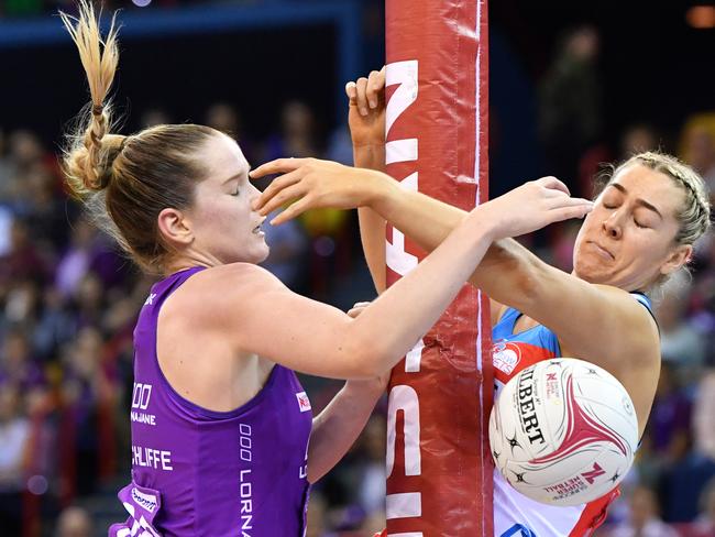 Tara Hinchliffe and Sophie Garbin collide with the goalpost during a tussle in Sunday’s match.