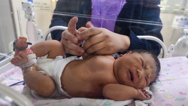 A nurse takes care of a newborn baby at a hospital in Fuyang, in China's eastern Anhui province. Picture: AFP