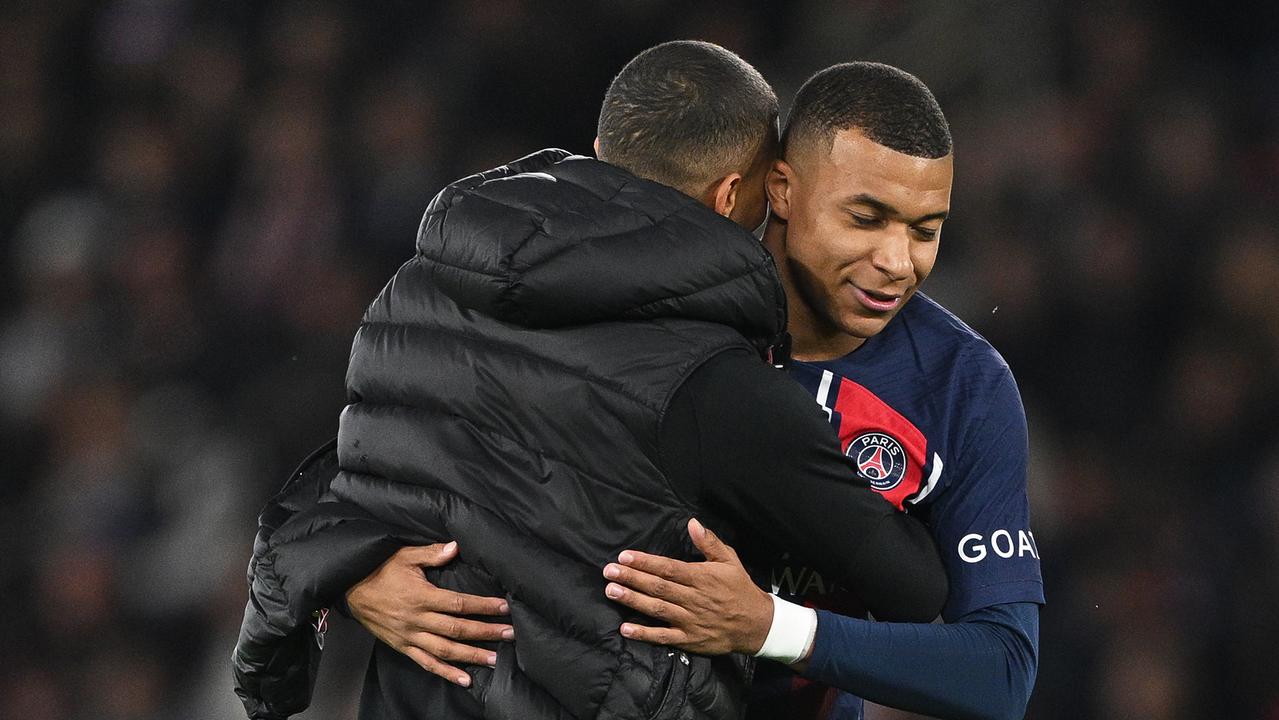 PARIS, FRANCE - OCTOBER 25: A pitch invader embraces Kylian Mbappe of Paris Saint-Germain during the UEFA Champions League match between Paris Saint-Germain and AC Milan at Parc des Princes on October 25, 2023 in Paris, France. (Photo by David Ramos/Getty Images)
