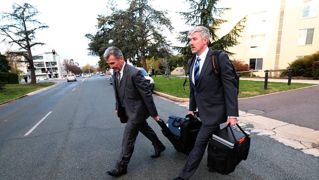 Federal police officers after raiding the home of Annika Smethurst this week.