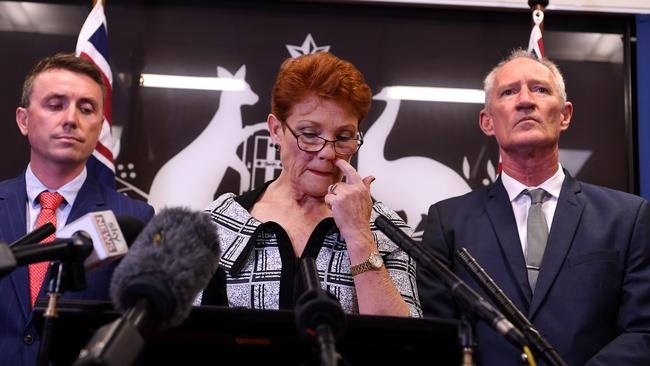 Queensland senator and One Nation leader Pauline Hanson (centre), flanked by party officials James Ashby (left) and Steve Dickson, while speaking to reporters at a press conference in Brisbane yesterday. Picture: AAP IMAGE/DAN PELED