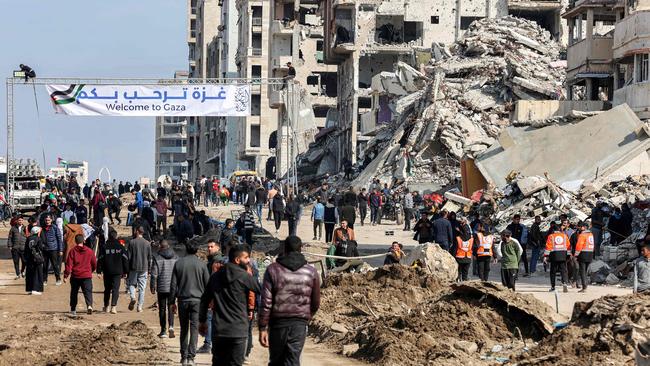 Gazans near the coastal al-Rashid Street try to cross from the Israeli-blocked Netzarim corridor from the southern Gaza Strip into Gaza City on January 26. Picture: AFP