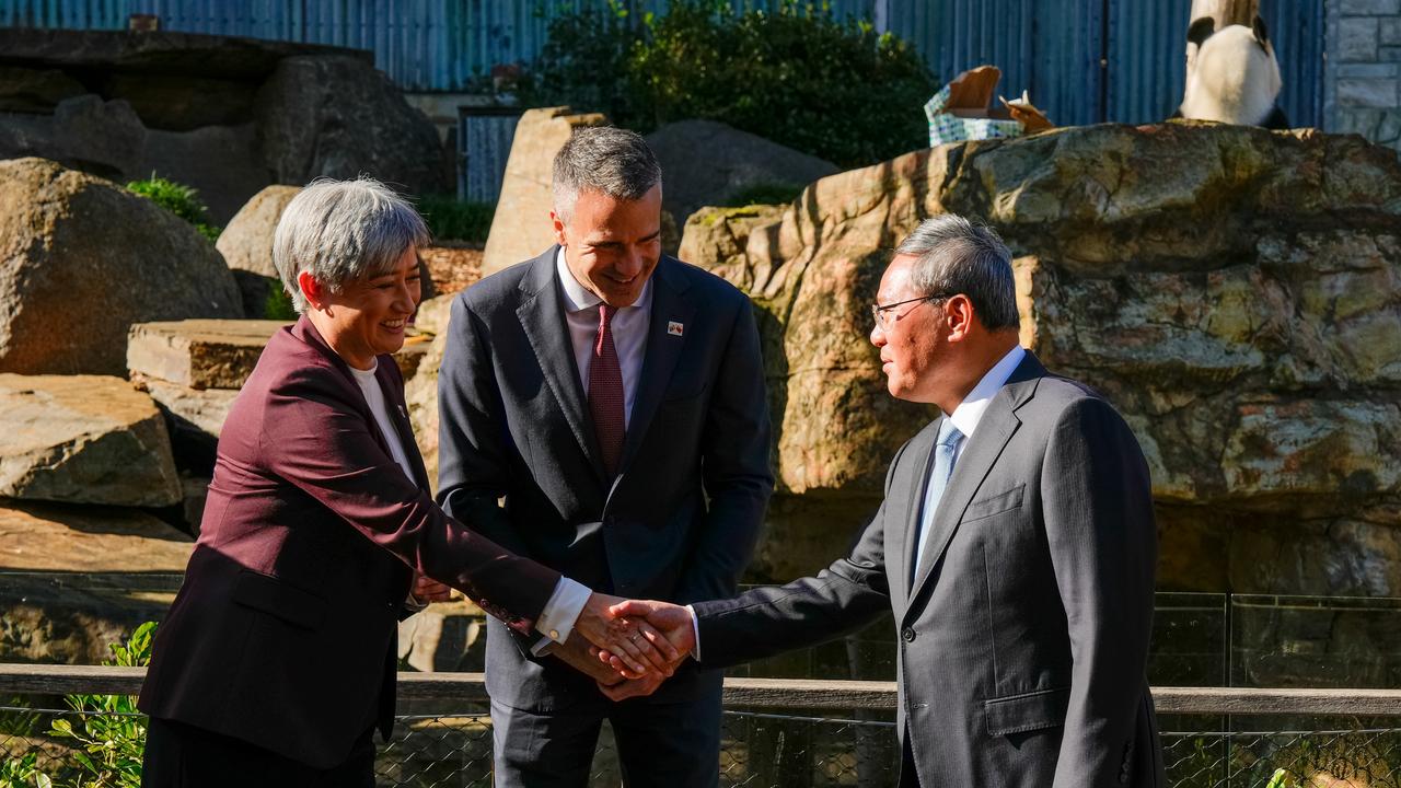 Foreign Affairs Minister Penny Wong shakes hands with China's Premier Li Qiang as South Australian Premier Peter Malinauskas looks on at Adelaide Zoo on Sunday. Picture: Asanka Ratnayake/Getty Images