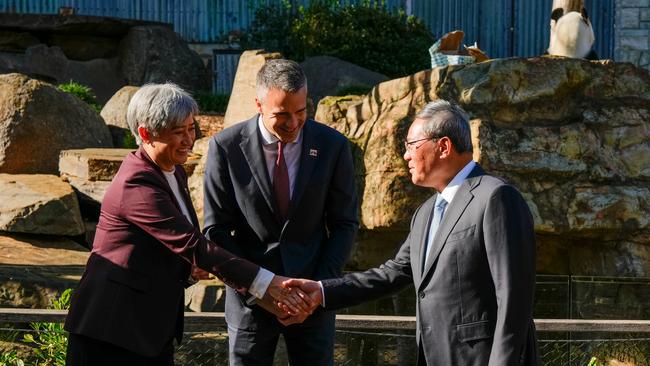 Foreign Affairs Minister Penny Wong shakes hands with China's Premier Li Qiang as South Australian Premier Peter Malinauskas looks on at Adelaide Zoo on Sunday. Picture: Asanka Ratnayake/Getty Images