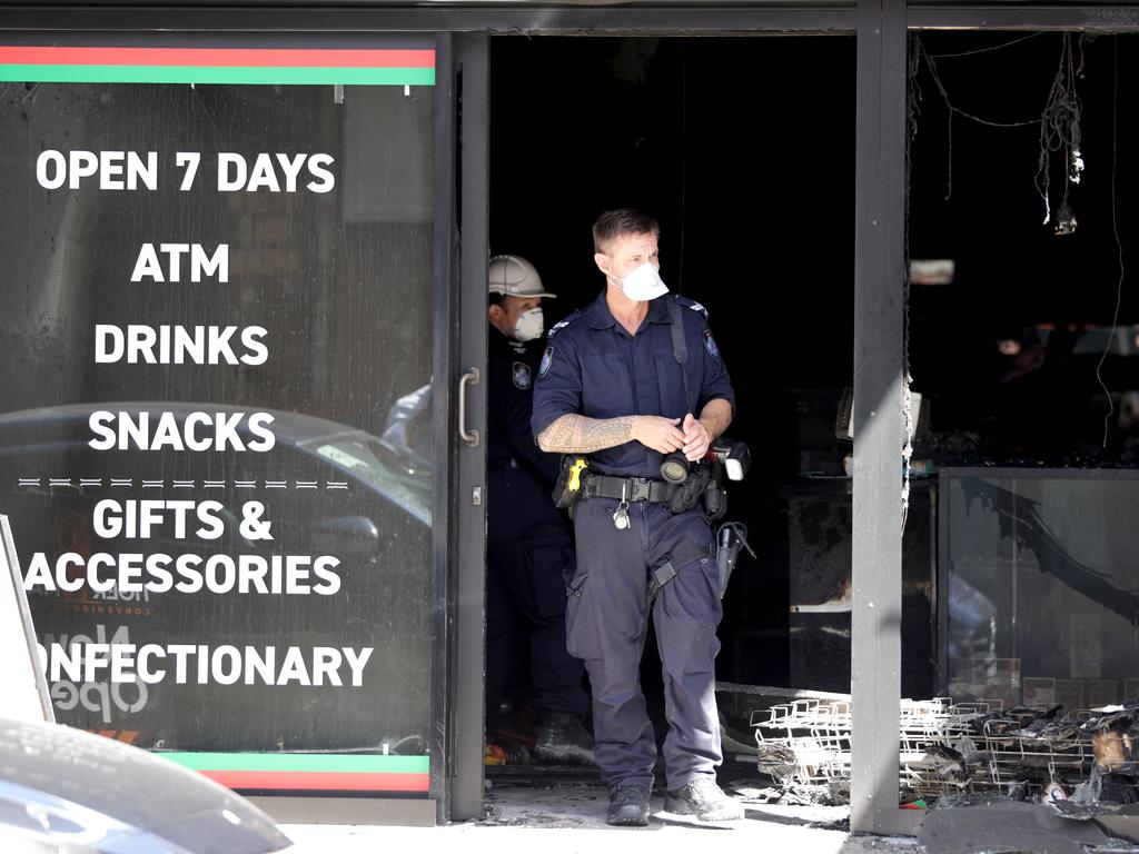 Police at the scene of the alleged arson attack at a convenience shop business next to the Prohibition nightclub on Wickham St. Picture: Steve Pohlner