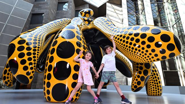 Yayoi Kusama’s monumental yellow-and-black polka-dotted Dancing Pumpkin sculpture has already been unveiled at the NGV, for all visitors to see. Pictured: Niko, 6 and Felix, 10 with the dancing pumpkin. Picture: Josie Hayden