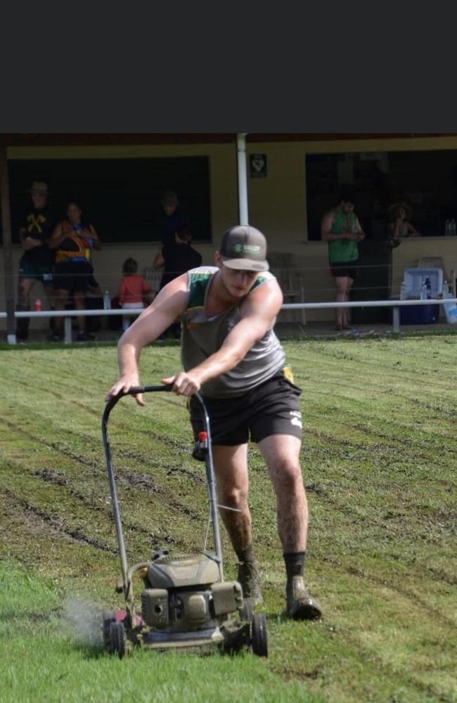 First grade Axeman player Alex Bunt doing his part to mow the field after wet weather has destroyed the fields.