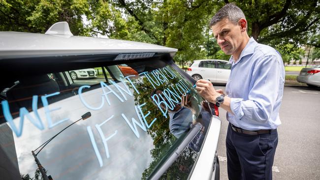 You may notice police vehicles with slogans written on them from Sunday. Picture: Jake Nowakowski