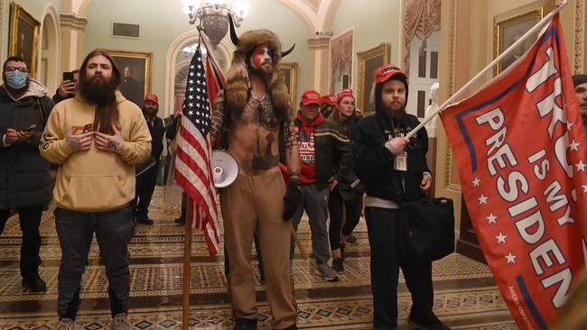 Supporters of Donald Trump, including member of the QAnon conspiracy group Jake Angeli, aka Yellowstone Wolf (centre), enter the US Capitol in Washington, DC. Picture: Saul Loeb/AFP