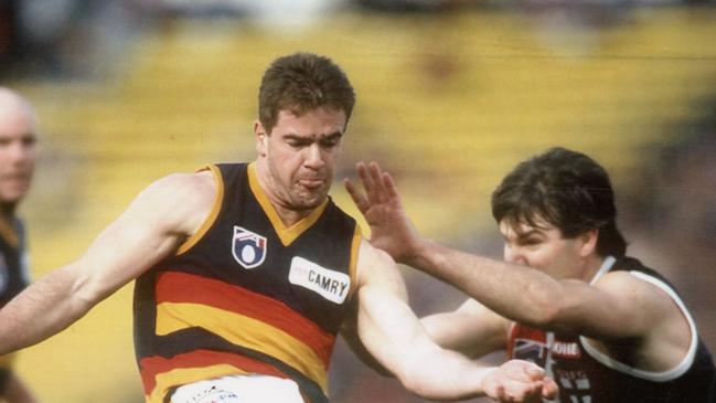 Adelaide’s Mark Ricciuto takes on St Kilda’s Danny Frawley in 1995 at Waverley. Picture: Tony Feder from Sporting Pix.