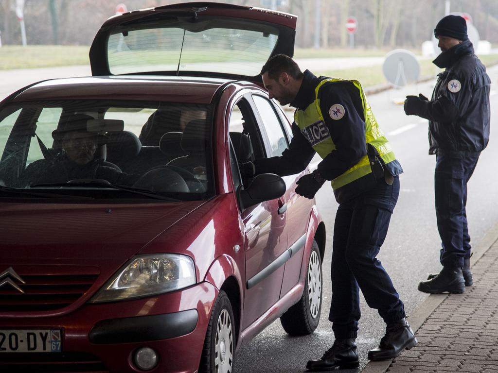 Police officers control cars at the boarder crossing at the highway A35 between Woerth (Germany) and Strassbourg the day after a man shot 14 people. Picture: Getty