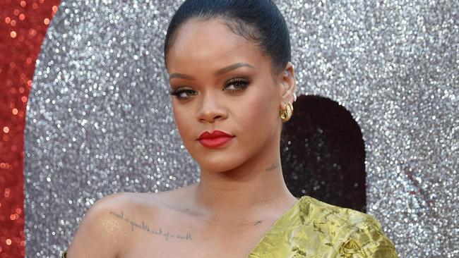 Barbadian singer and actress Rihanna poses on the carpet upon arrival to attend he European premiere of the film " Ocean's 8" in London on June 13, 2018. / AFP PHOTO / Anthony HARVEY