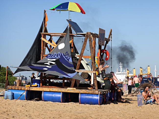 Protesters watch on as a barge leaves Newcastle Port from Horseshoe beach, Newcastle during the Newcastle Port protest. Photographer: Adam Yip