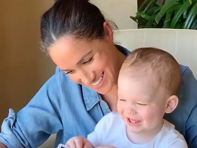 TOPSHOT - This handout still image released on May 6, 2020, on the @SaveChildrenUK Instagram account of the charity Save the Children, and taken from a video filmed in California, US, by Britain's Prince Harry, Duke of Sussex, shows Meghan, Duchess of Sussex reading from the book Duck! Rabbit! to their son Archie, on his first birthday. - The Duke and Duchess released the video to support Save the Children's Save With Stories initiative, which is aimed at helping children hardest hit by the COVID-19 crisis in the UK and around the world. (Photo by The Duke and Duchess of Sussex / various sources / AFP) / RESTRICTED TO EDITORIAL USE - MANDATORY CREDIT 