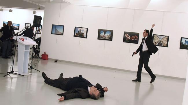 Mevlut Mert Altintas (right) shot dead Andrey Karlov, the Russian ambassador to Turkey (on the floor) at an art gallery in Ankara. Picture: AFP/Sozcu daily/Yavuz Alatan