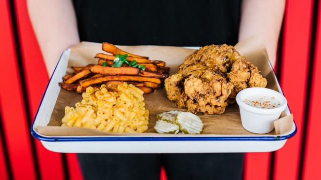 The fried chicken thighs with sweet potato fries and mac ‘n’ cheese. Picture: Alana Dimou