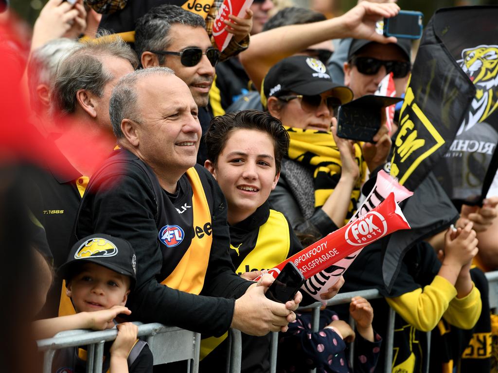 Football fans line up to watch the AFL Grand Final parade in Melbourne on Friday. Picture: AAP Image/Julian Smith