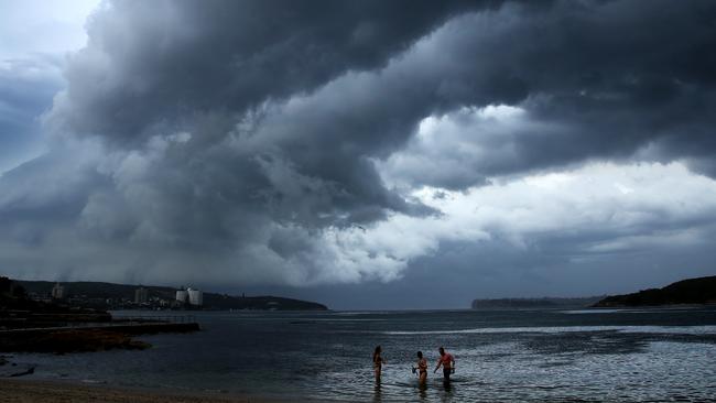 Swimmers leave the water as a storm front crosses Sydney Harbour at Fairlight Beach. Picture: Getty Images