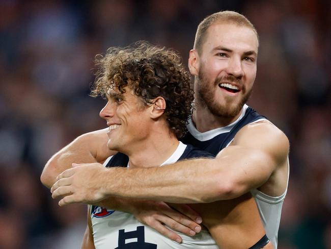 MELBOURNE, AUSTRALIA - MARCH 29: Charlie Curnow of the Blues celebrates a goal with teammate Harry McKay during the 2024 AFL Round 03 match between the North Melbourne Kangaroos and the Carlton Blues at Marvel Stadium on March 29, 2024 in Melbourne, Australia. (Photo by Dylan Burns/AFL Photos via Getty Images)
