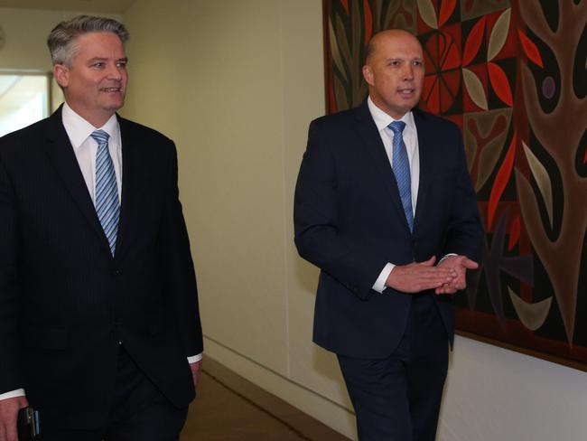 Friends Mathias Cormann and Peter Dutton arrive after enjoying a dinner together last night. Picture: Kym Smith