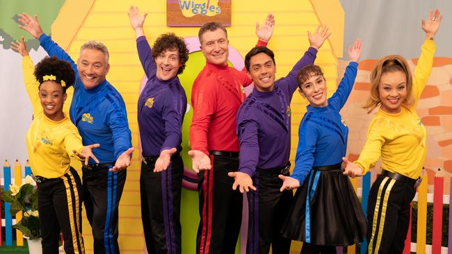 John Pearce (purple, right) with the cast of The Wiggles.