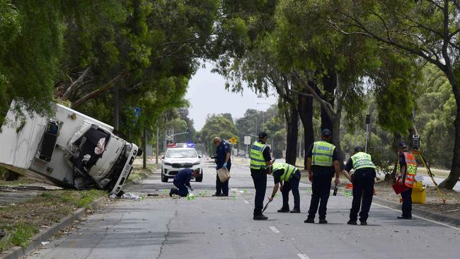 Police examine the scene of the crash. Picture: Bianca De Marchi